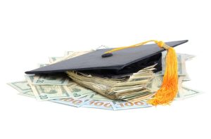 Graduation cap with college scholarship money